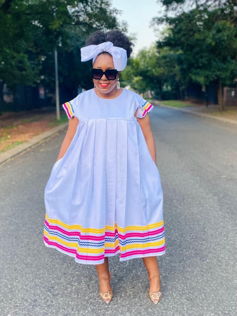 Plus size flared sleeve dress, white with rainbow stripe trim at sleeves and hem