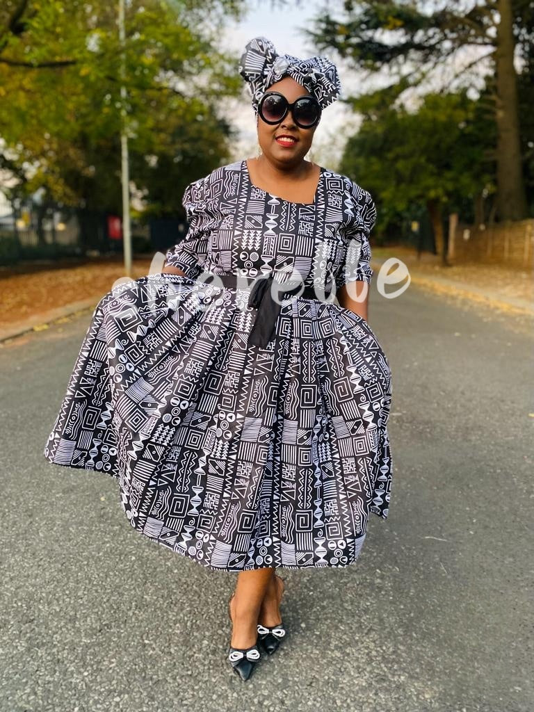 Belted geometric midi dress with puff sleeves in black-and-white