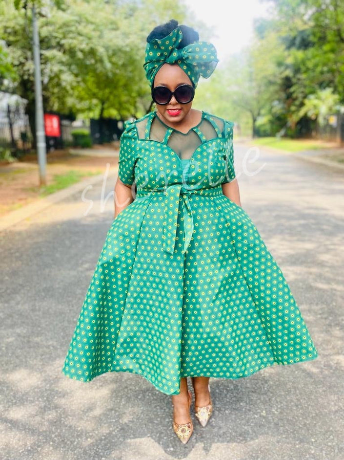 Green patterned midi dress with matching headwrap, tie waist