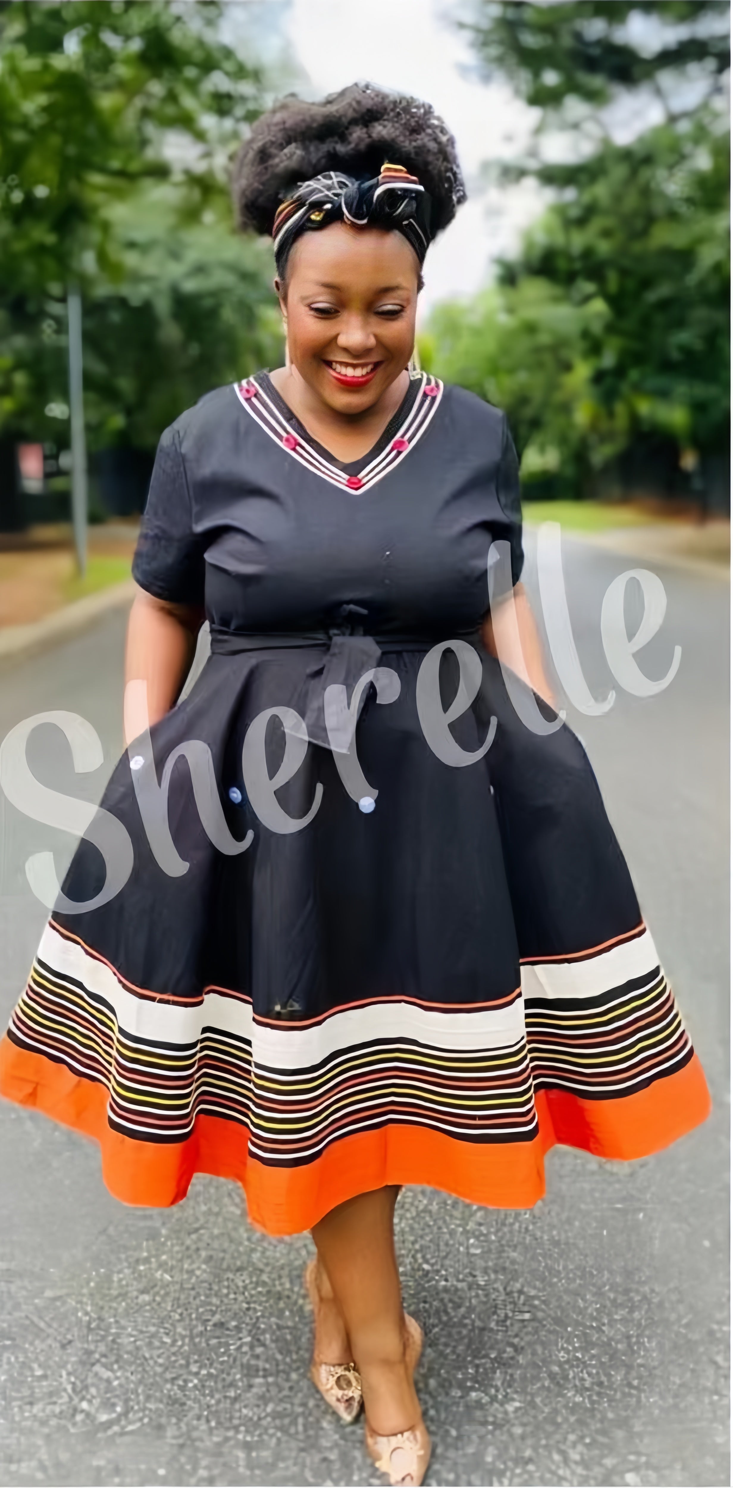 Belted midi dress with V-neck, black fabric, striped hem with orange border