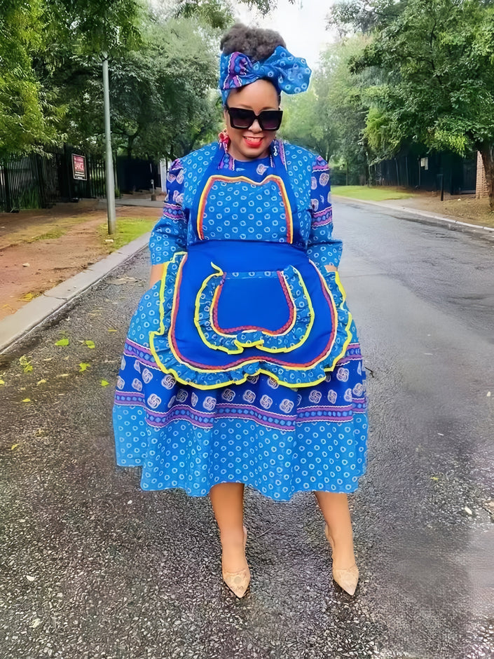 Blue layered African print dress with red trim, square neckline and puff sleeves