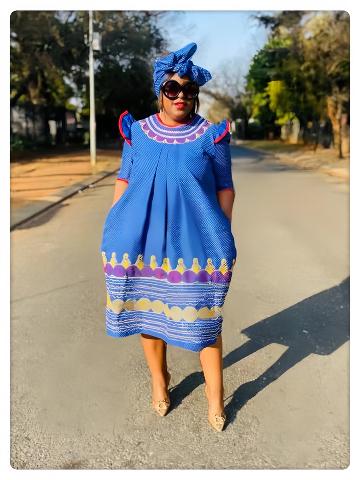 Blue traditional dress with scalloped edge hem and multicolor embroidered trim