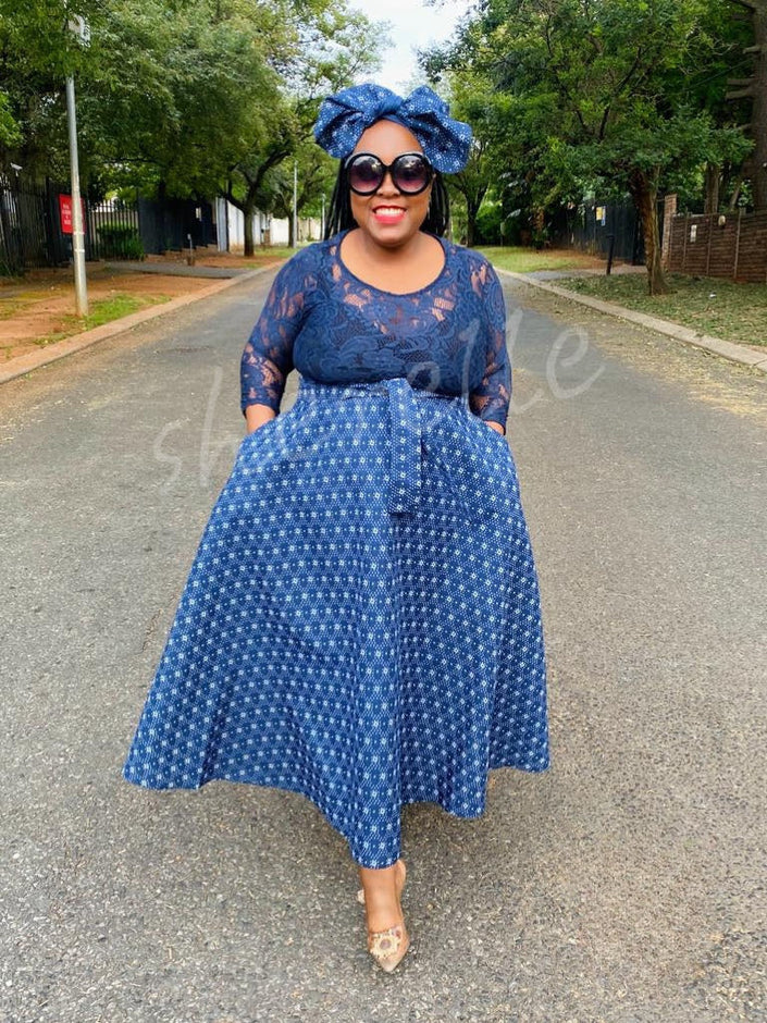 Geometric lace midi dress with 3/4 sleeves, navy blue bodice and patterned skirt