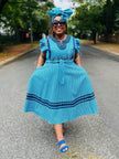 Blue shweshwe-style dress with puff sleeves and flared skirt