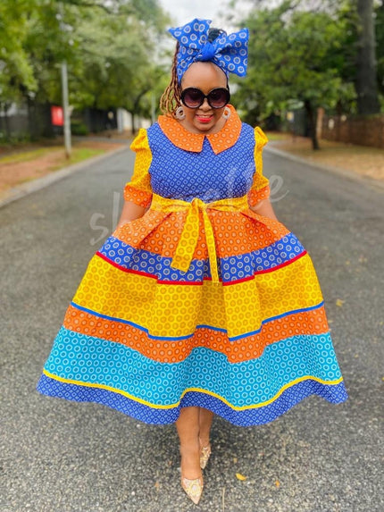 Colorful ruffle midi dress with matching patterned headwrap, blue and orange geometric print