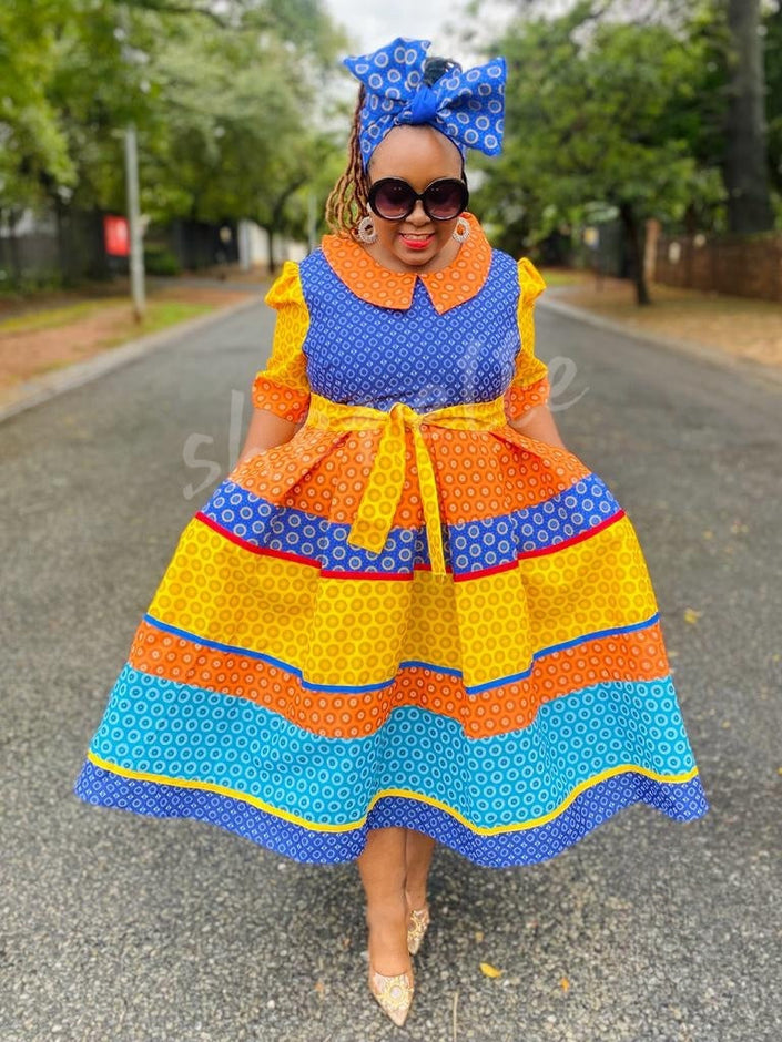 Colorful ruffle midi dress with matching patterned headwrap, blue and orange geometric print