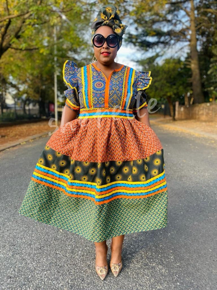 Multicolor puff-sleeve midi dress with ruffled blue yoke, orange tiers, green patterned skirt