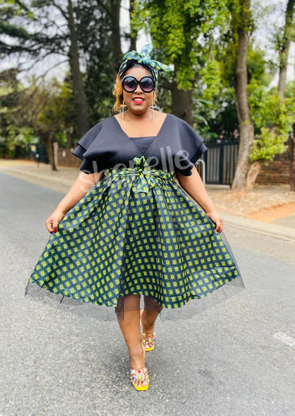 V-neck geometric skirt dress with bow waist, dark top and green patterned skirt