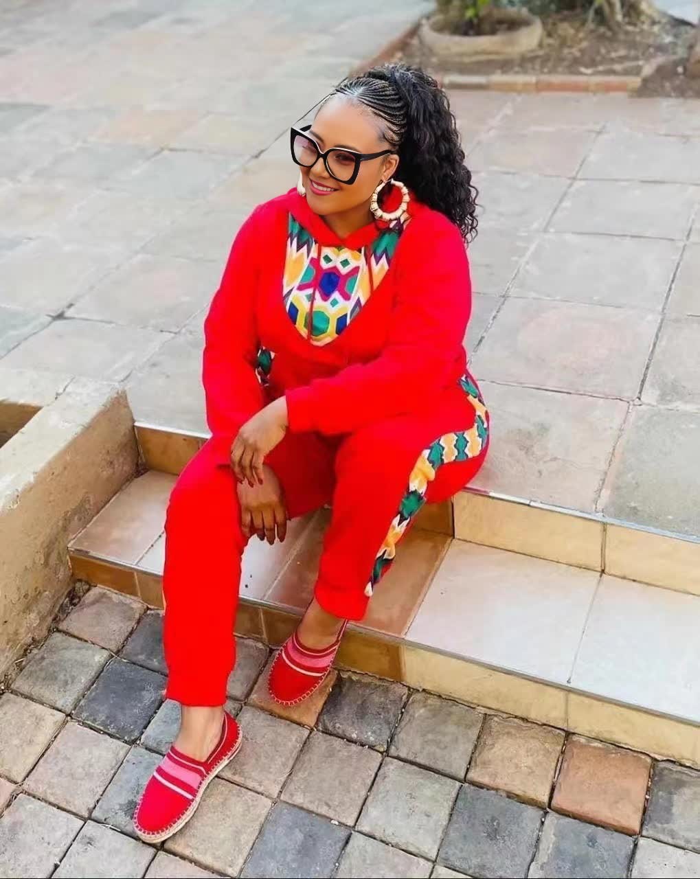 African print twin set, red long-sleeve top and matching pants with colorful neckline trim