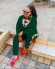 African print twin set, green long-sleeve top and pants with colorful neckline and cuffs