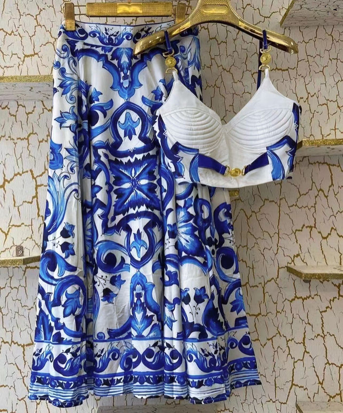 Ruched white bra top with blue trim and matching blue-and-white patterned midi skirt