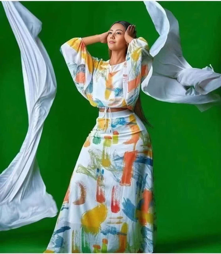 Printed top and skirt set with puff sleeves, multicolor abstract pattern.