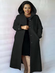 Knee-length hooded coat in black with button front, long sleeves, and side pockets