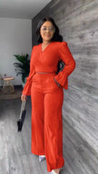 Orange-red V-neck puff-sleeve jumpsuit with wrap waist and wide straight legs