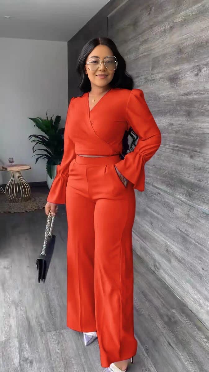 Orange-red V-neck puff-sleeve jumpsuit with wrap waist and wide straight legs