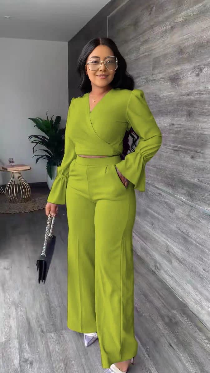 Bright lime green V-neck puff-sleeve jumpsuit with wrap waist and wide straight legs