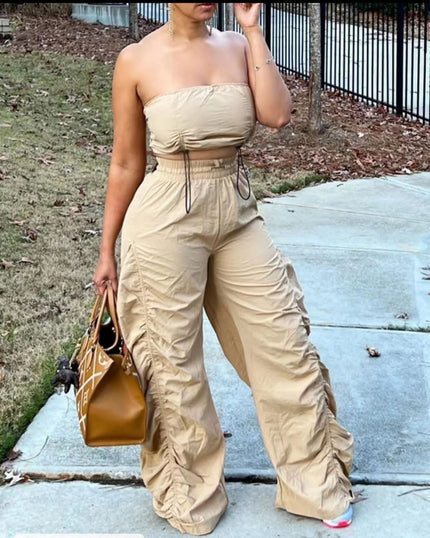 Beige strapless jumpsuit with ruched bodice, drawstring waist, wide-leg pants