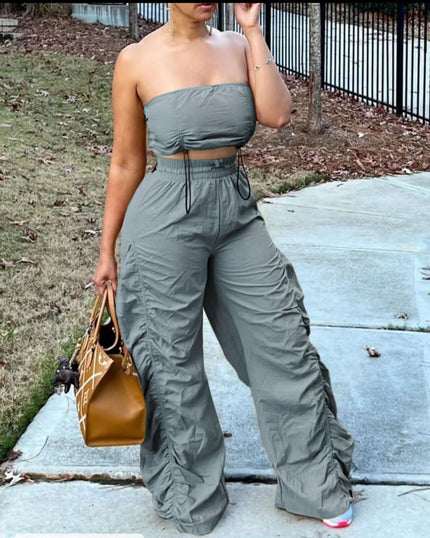 Grey strapless jumpsuit with ruched bodice, drawstring waist, wide-leg pants