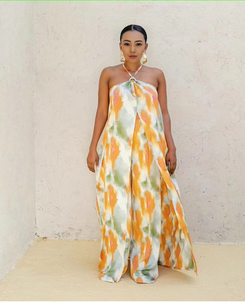 Halter maxi dress with neck tie, sleeveless draped bodice, abstract orange and white print