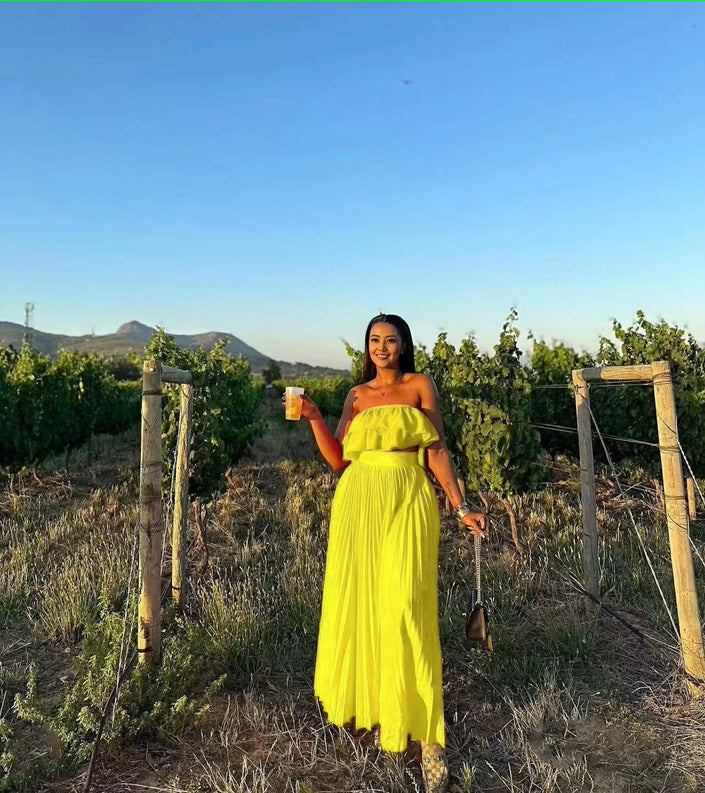 Off-shoulder yellow maxi dress with ruffle trim at bust and tiered skirt