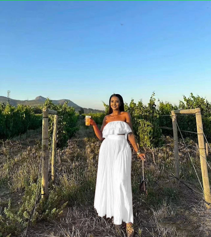 Off-shoulder white maxi dress with ruffle trim at bust and tiered skirt