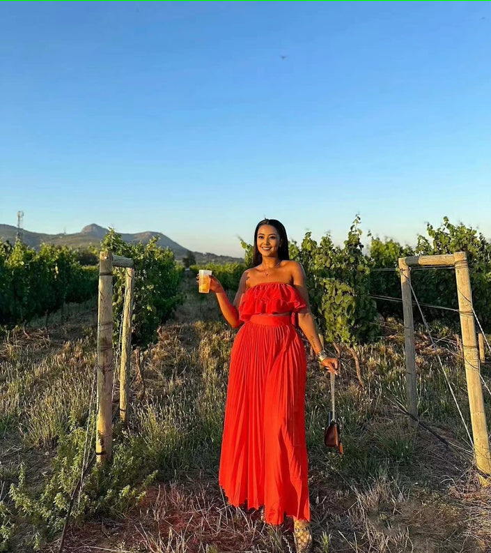 Off-shoulder red maxi dress with ruffle trim at bust and tiered skirt