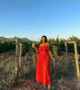 Off-shoulder red maxi dress with ruffle trim at bust and tiered skirt