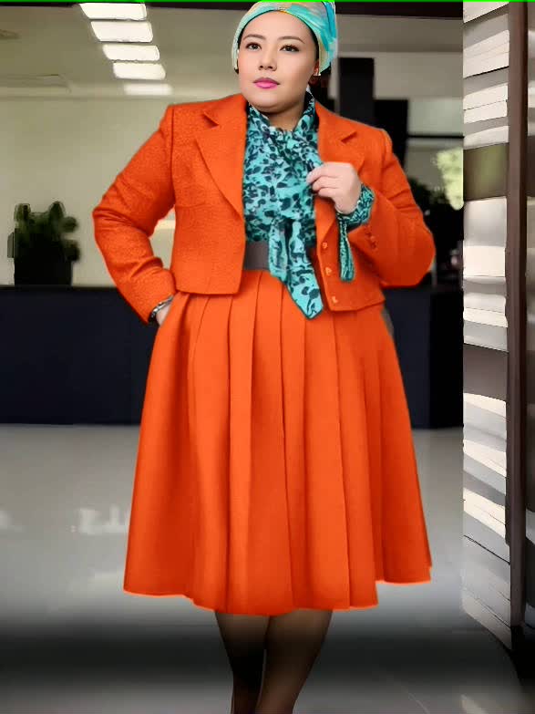 Orange pleated skirt suit set with tailored blazer jacket and pleated midi skirt
