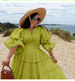 Green tiered midi dress with puff sleeves and V-neck bodice
