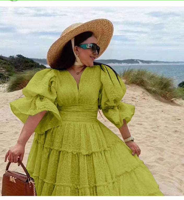 Green tiered midi dress with puff sleeves and V-neck bodice