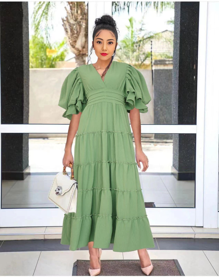 Green tiered midi dress with short puff sleeves and tiered skirt