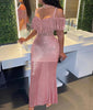 Pink mermaid maxi dress with off-shoulder sequins and fringe sleeve details, fitted flare