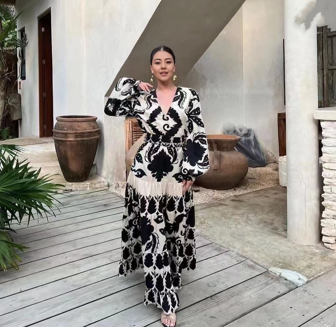 Black-and-white patterned maxi dress with fitted waist, V-neck and long puff sleeves