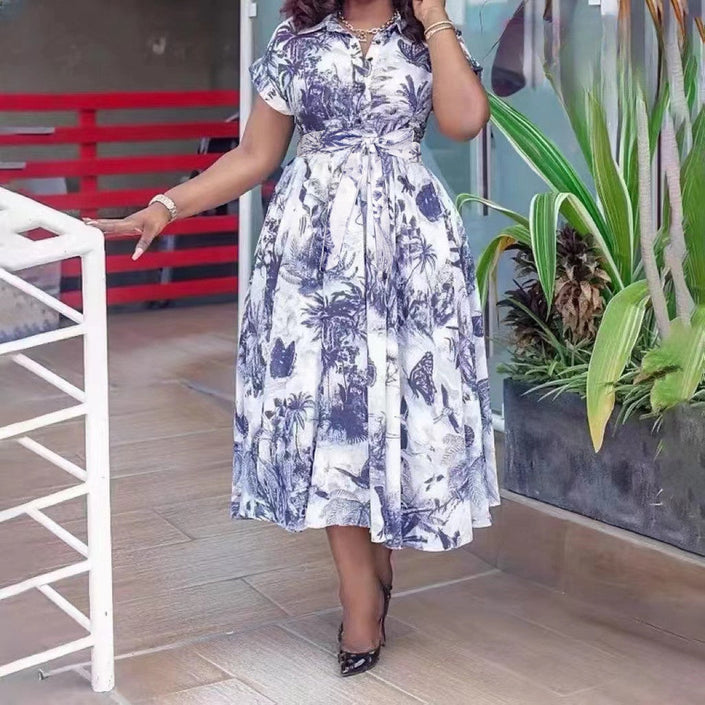Tropical print midi dress with belted waist, white base and blue floral leaves, fit-and-flare