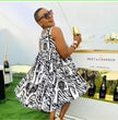 Black and white animal print sleeveless flared dress with high neckline
