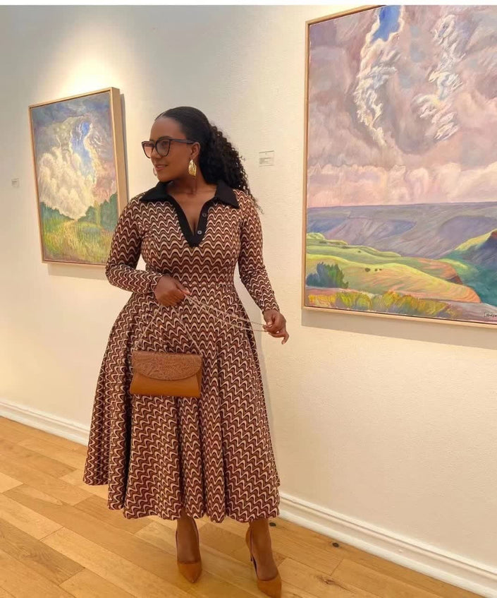 Geometric flared midi dress with long sleeves, V-neck, and brown-and-cream zigzag pattern