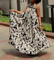 Halter maxi dress with flowing black-and-white floral print, sleeveless with open back