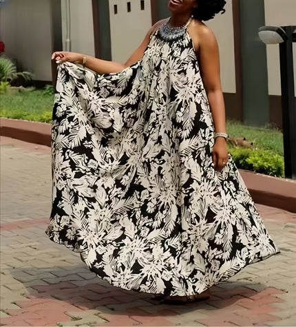 Halter maxi dress with flowing black-and-white floral print, sleeveless with open back