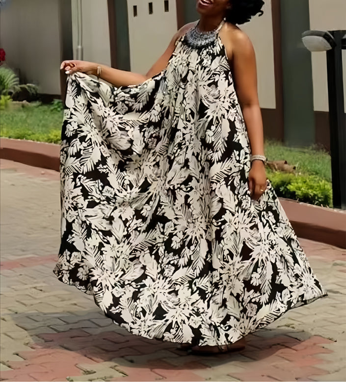 Halter maxi dress with flowing black-and-white floral print, sleeveless with open back