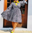 Plus size printed midi dress with black-and-white geometric pattern, V-neck, long sleeves.