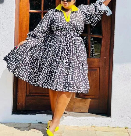 Plus size printed midi dress with black-and-white geometric pattern, V-neck, long sleeves.