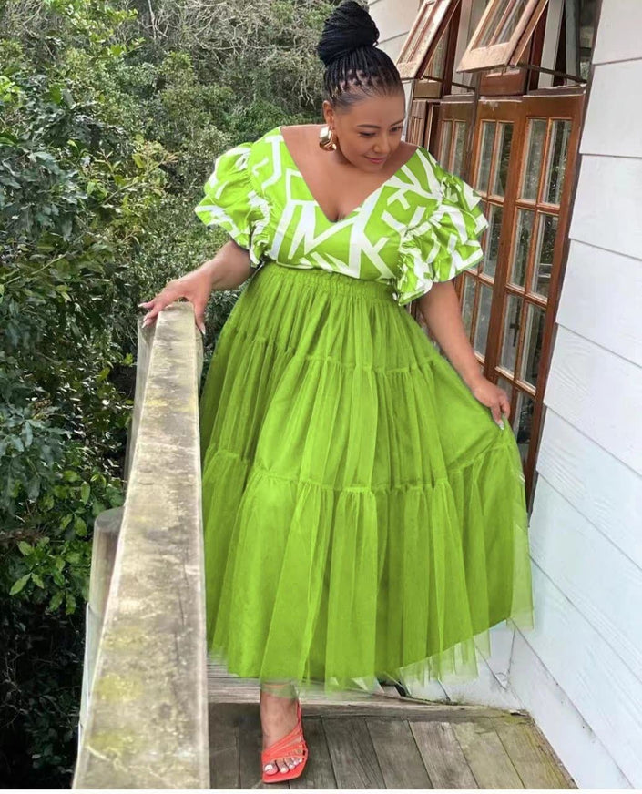 Yellow-green tiered tulle maxi dress with ruffled puff sleeves and white pattern bodice