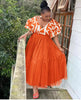 Orange-red tiered tulle maxi dress with ruffled puff sleeves and white pattern bodice