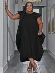 Black plus size midi dress with ruffle sleeves and loose gathered skirt
