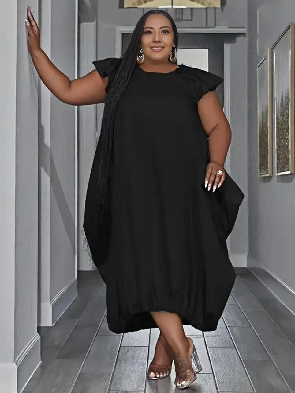 Black plus size midi dress with ruffle sleeves and loose gathered skirt