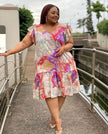 Plus size ruffle-sleeve printed dress, colorful floral print, V-neck, tiered hem.