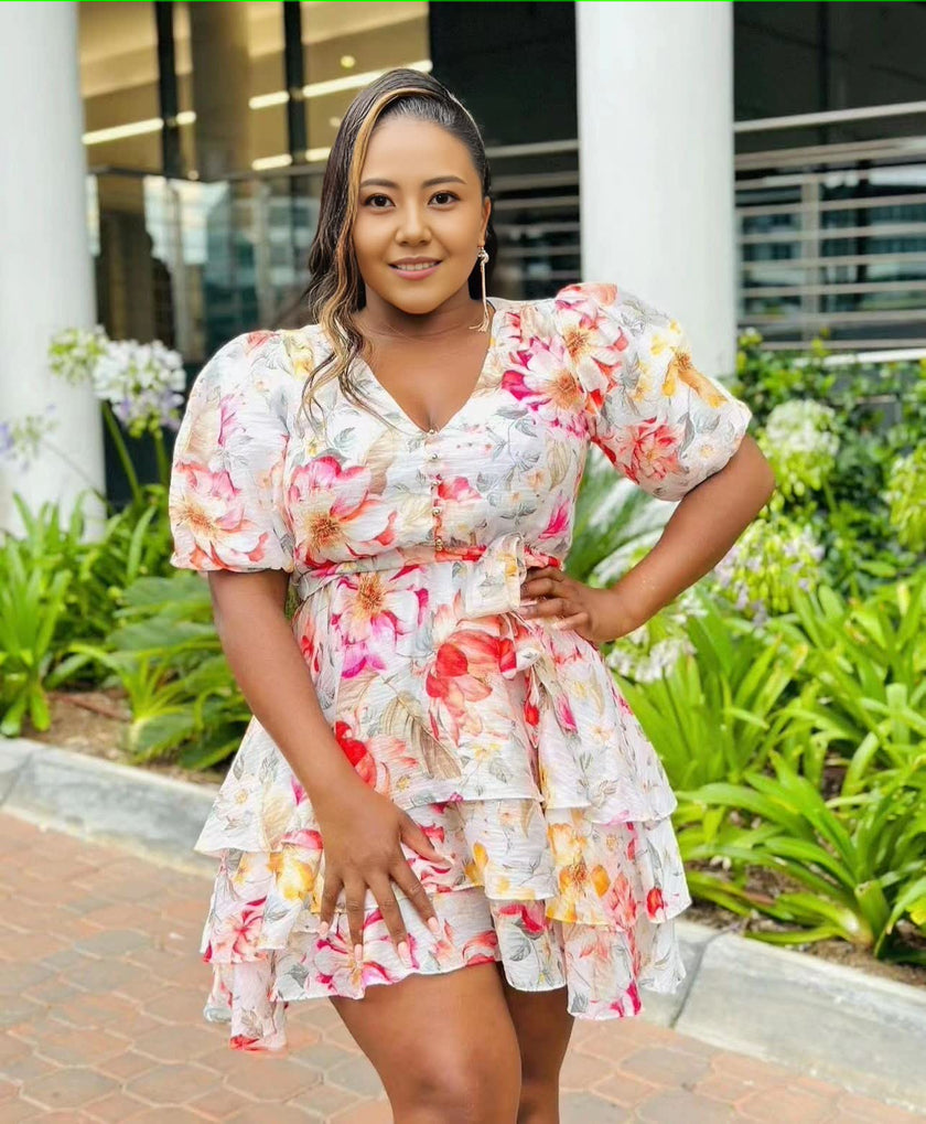 Floral ruffle mini dress with puff sleeves, tiered skirt, and V-neck