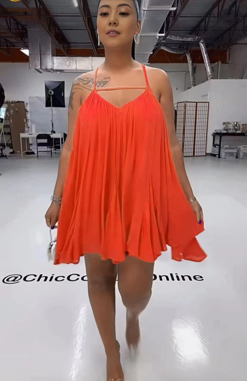 Sleeveless flared dress in orange-red with thin straps and V neckline