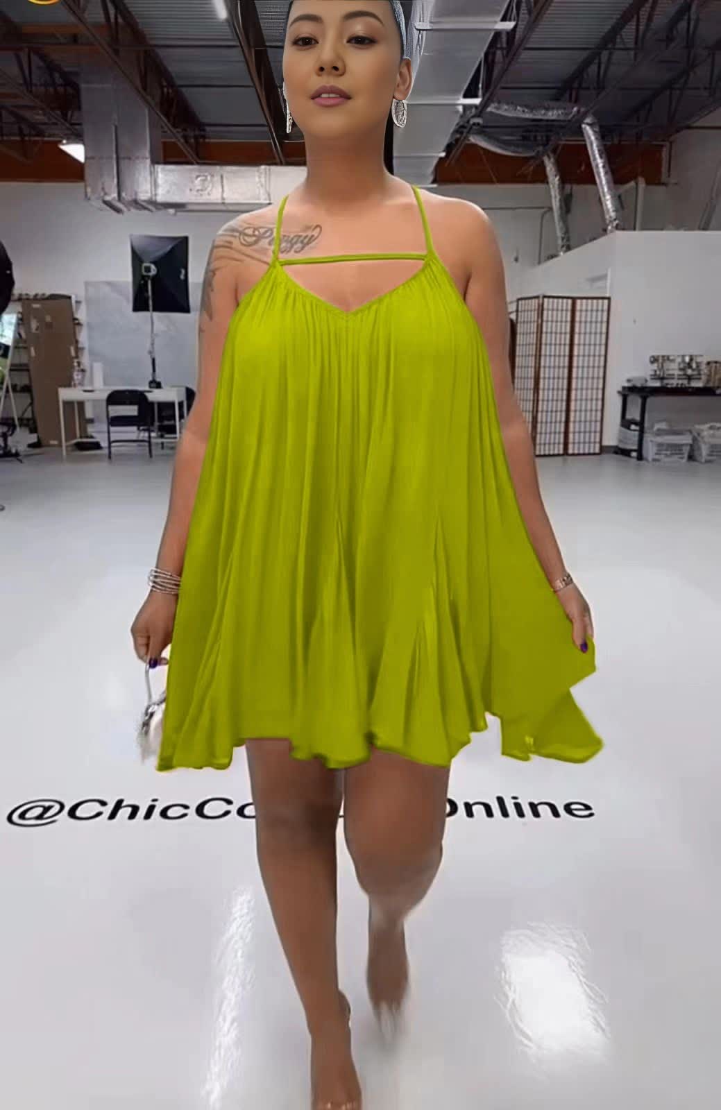 Sleeveless flared dress in green-yellow with thin straps and V neckline