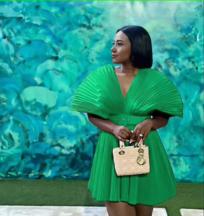 Pleated mini dress with V-neck and pleated puff sleeves, vibrant green.